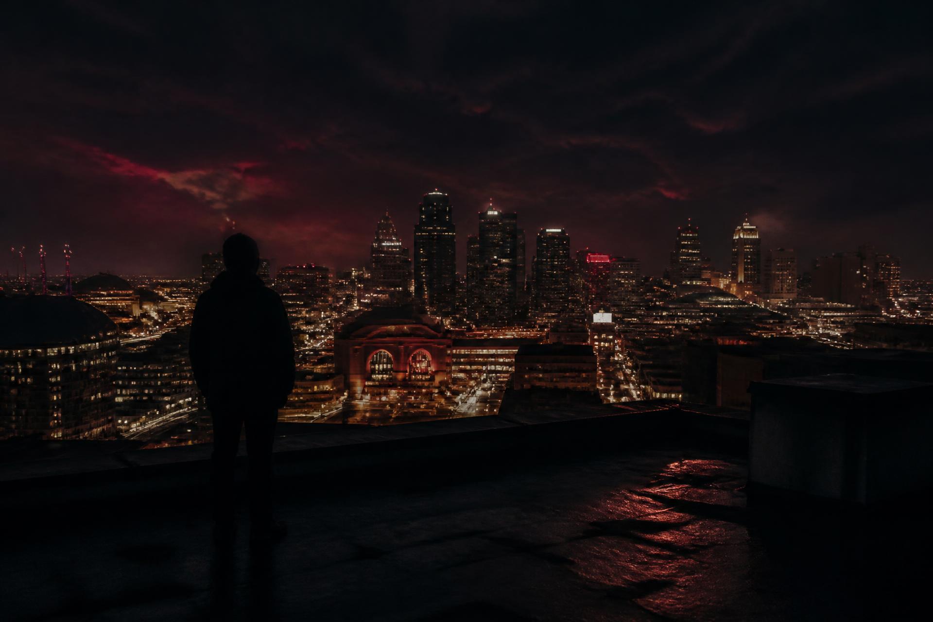 Kansas City skyline at night behind a radio studio microphone